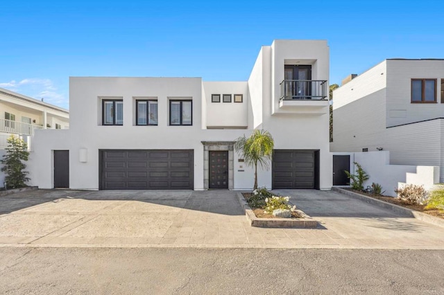 view of front of property with a balcony and a garage