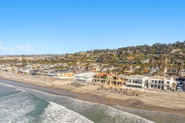 birds eye view of property featuring a beach view and a water view