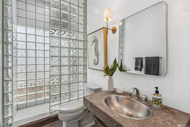 bathroom with toilet, sink, and walk in shower