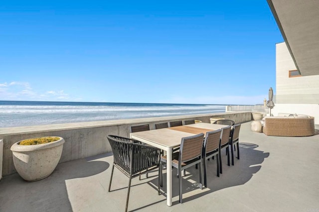 view of patio / terrace with a water view and a view of the beach