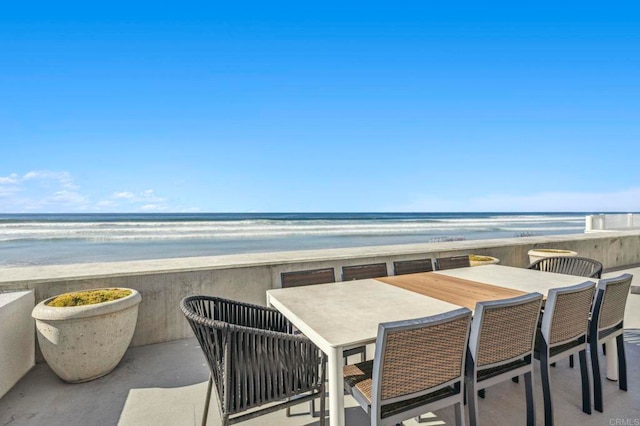 balcony featuring a water view and a beach view