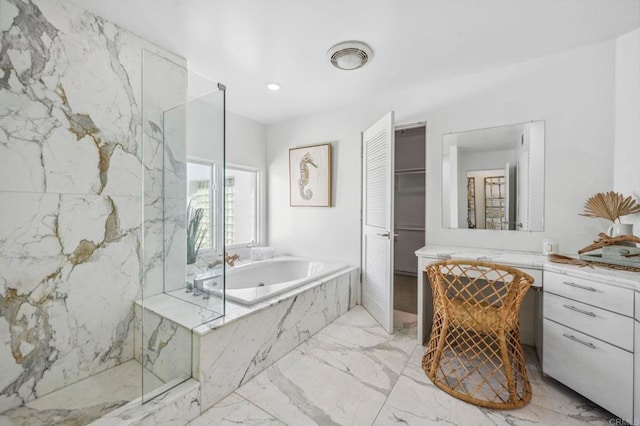 bathroom with vanity and separate shower and tub