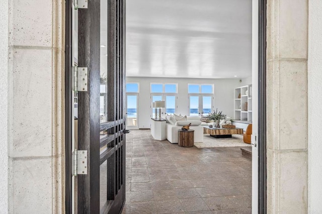 living room with a water view and french doors