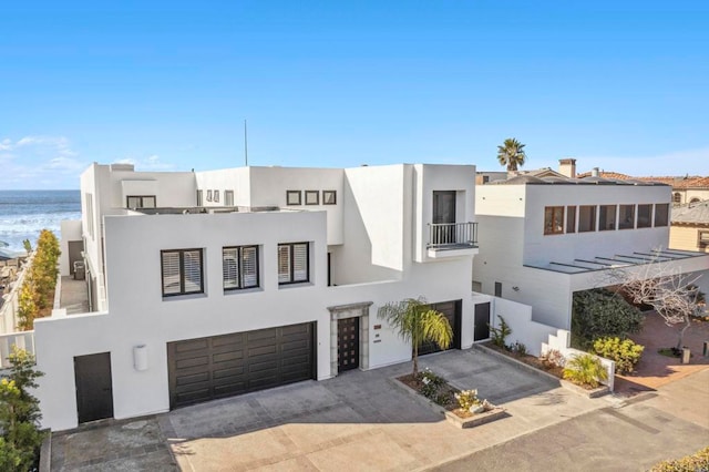 view of front of property with a water view and a garage