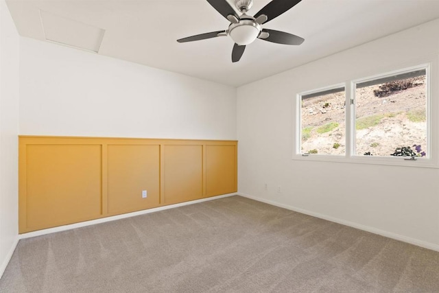 empty room featuring light carpet and ceiling fan