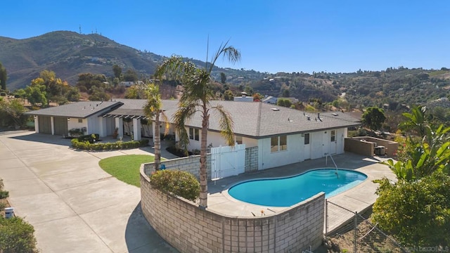 view of pool with central AC unit, a mountain view, and a patio