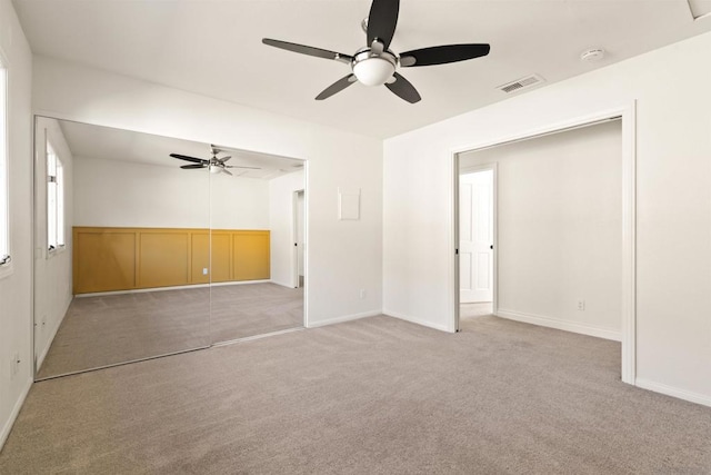 interior space featuring ceiling fan and light carpet