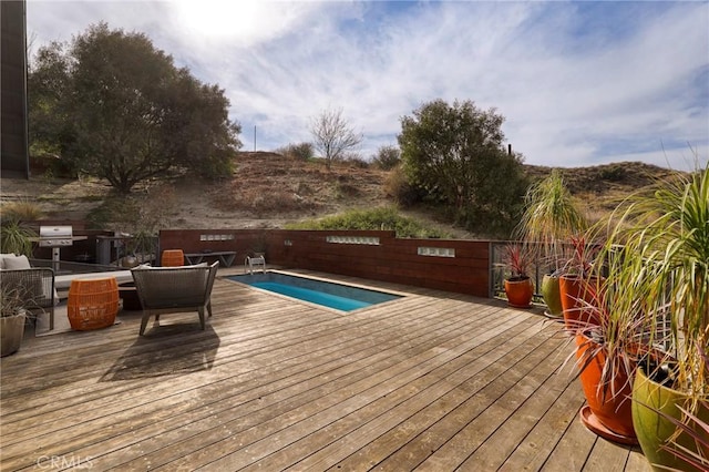 view of swimming pool featuring a deck