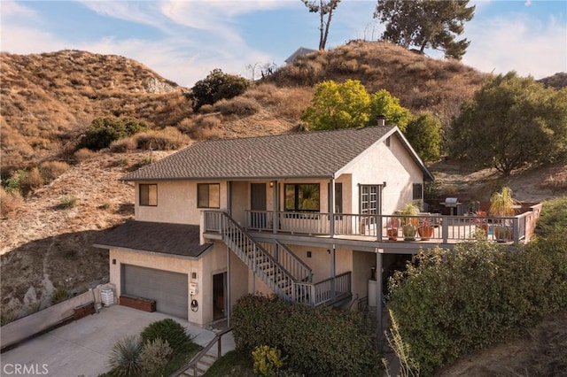 view of front of property with a garage and a mountain view