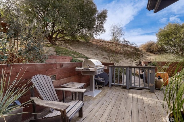 wooden terrace featuring grilling area