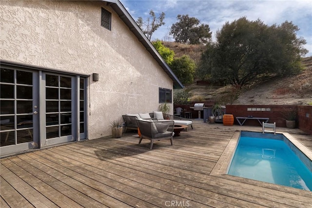 view of swimming pool with a deck