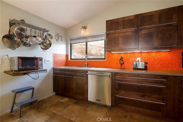 kitchen with stainless steel appliances, backsplash, sink, vaulted ceiling, and dark tile patterned floors