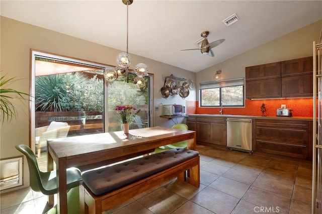 tiled dining room featuring ceiling fan and lofted ceiling