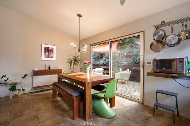 tiled dining room featuring lofted ceiling and a notable chandelier