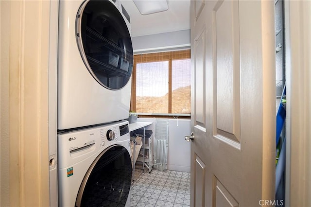 clothes washing area featuring stacked washer / drying machine