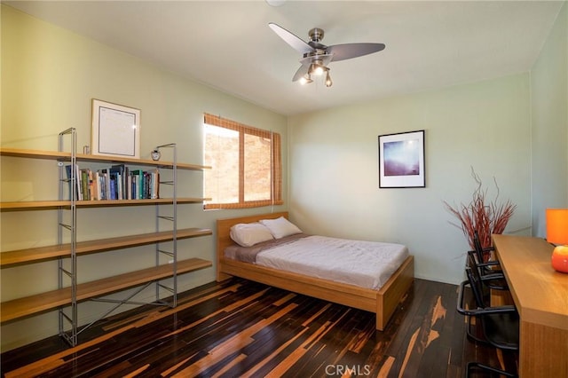 bedroom with ceiling fan and dark hardwood / wood-style flooring