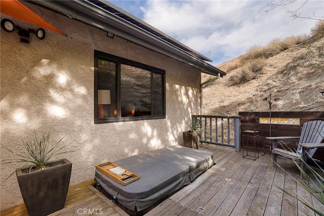 deck with a covered hot tub