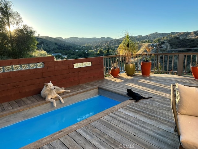 view of pool featuring a deck with mountain view