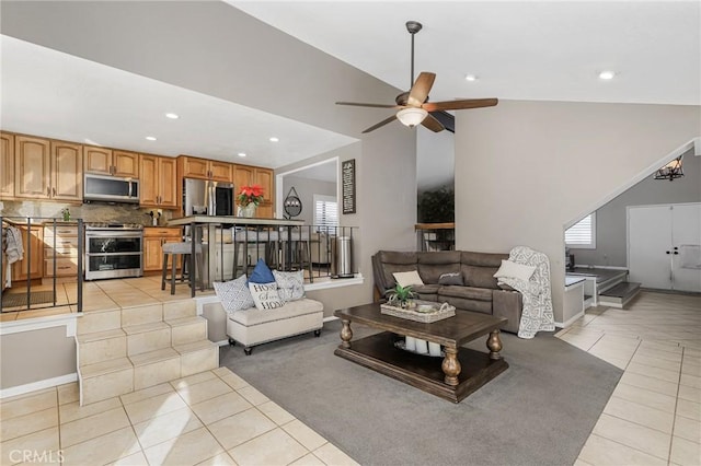 living room featuring vaulted ceiling, ceiling fan, and light tile patterned flooring