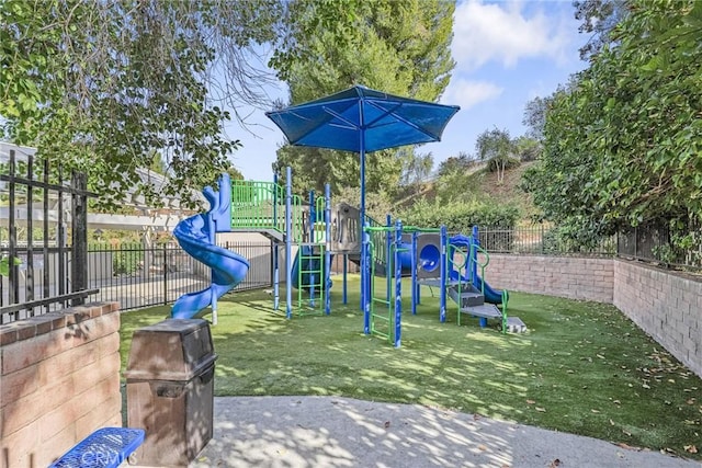 view of jungle gym featuring a lawn