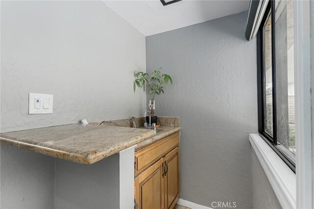 bar featuring lofted ceiling and sink