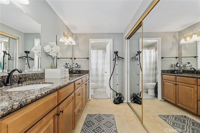 bathroom with toilet, vanity, and a shower with shower curtain