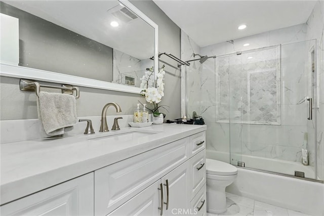 full bathroom featuring toilet, bath / shower combo with glass door, and vanity