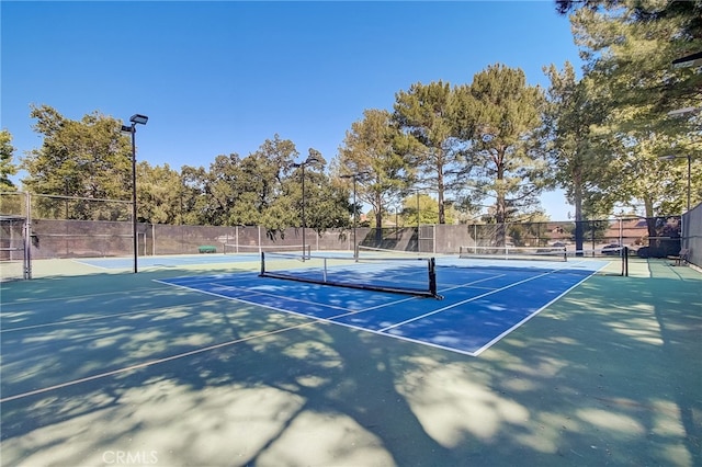 view of sport court with basketball hoop