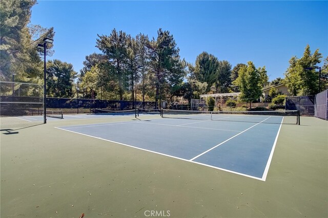 view of sport court featuring basketball hoop