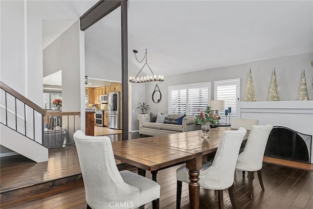 dining space with an inviting chandelier and dark hardwood / wood-style floors