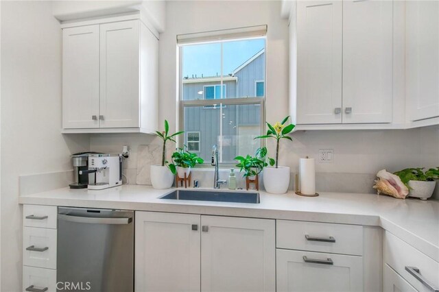 bar with white cabinets, dishwasher, and sink