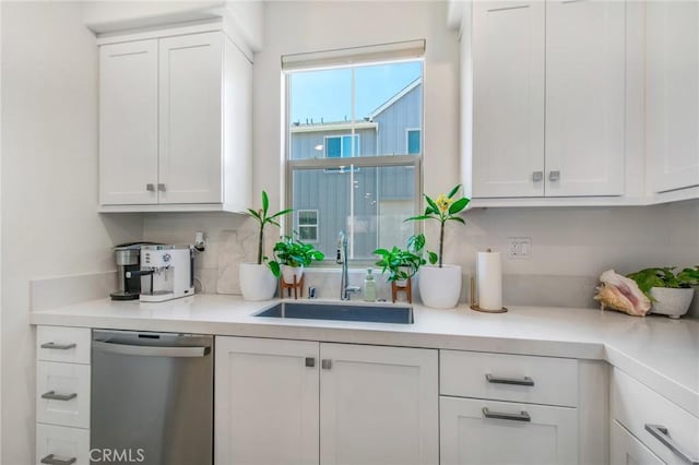 bar with sink, white cabinets, and stainless steel dishwasher