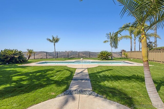 view of pool featuring a yard