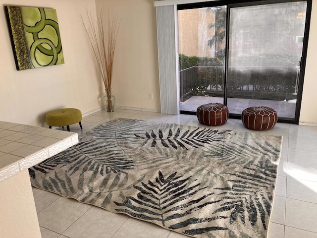 bedroom with access to exterior and light tile patterned floors