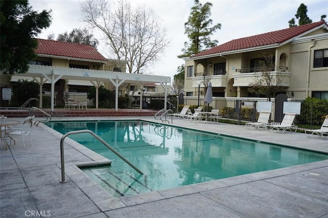 view of pool with a pergola and a patio area