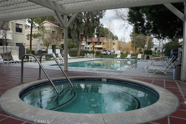 view of pool with a hot tub and a patio