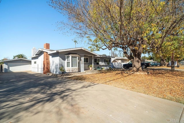 single story home with a garage and an outdoor structure