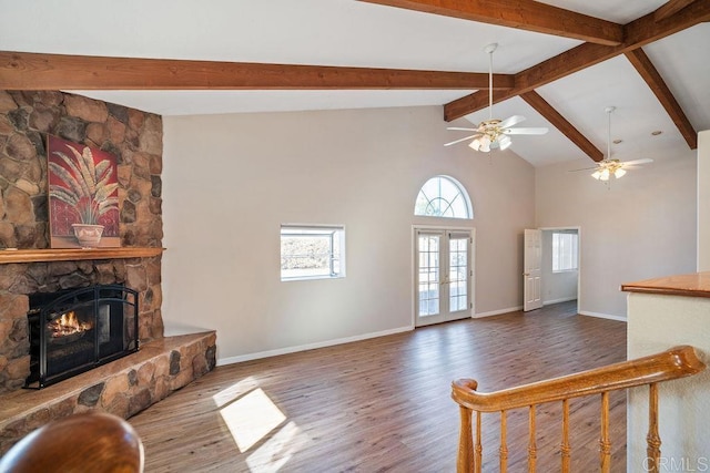 living room featuring high vaulted ceiling, ceiling fan, a fireplace, beamed ceiling, and wood-type flooring