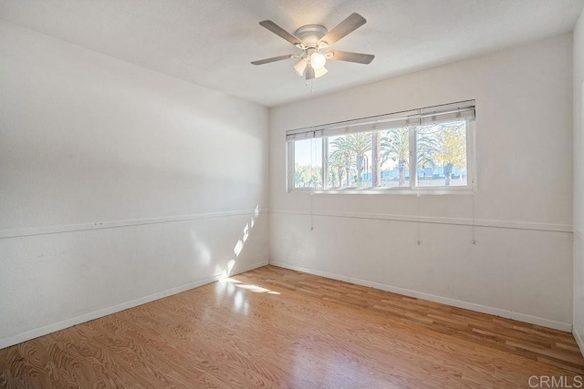 spare room with light hardwood / wood-style floors and ceiling fan