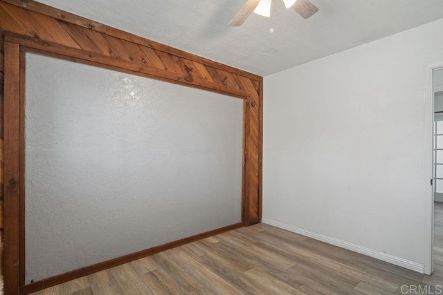 empty room featuring light hardwood / wood-style flooring and ceiling fan