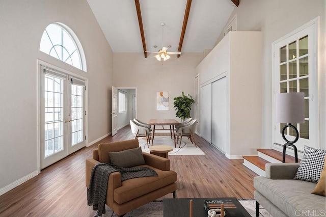 living room with high vaulted ceiling, french doors, ceiling fan, beamed ceiling, and wood-type flooring