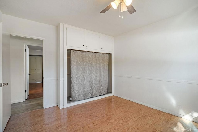 unfurnished bedroom featuring ceiling fan, a closet, and light hardwood / wood-style floors