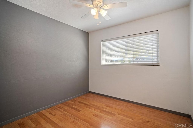 spare room featuring ceiling fan and light hardwood / wood-style flooring