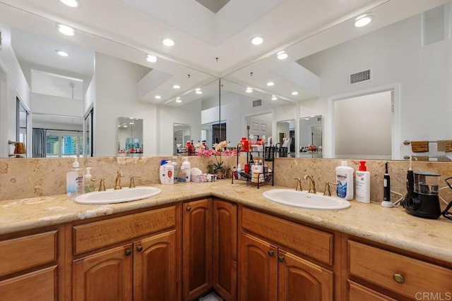 bathroom featuring decorative backsplash and vanity