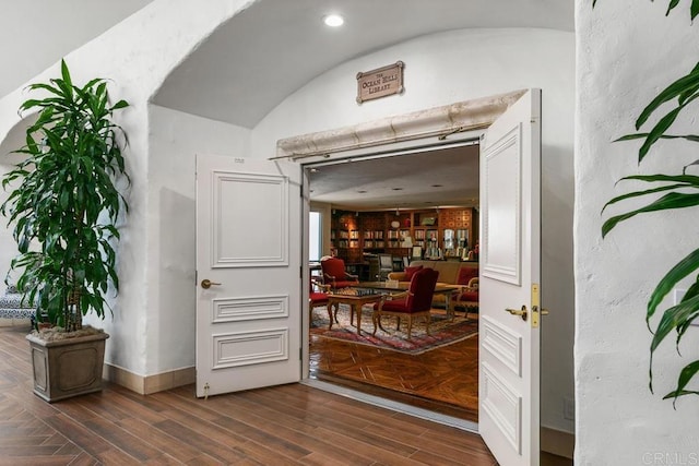 interior space featuring dark hardwood / wood-style flooring and vaulted ceiling