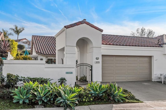 mediterranean / spanish-style home with a garage