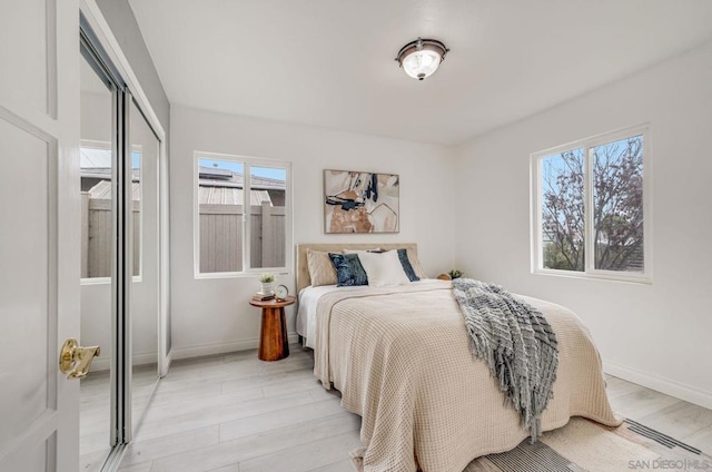 bedroom featuring a closet and light wood-type flooring