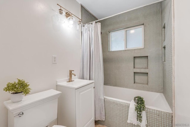 full bathroom featuring toilet, vanity, and shower / bathtub combination with curtain