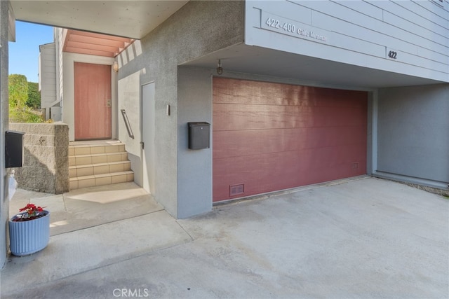 view of exterior entry featuring a garage