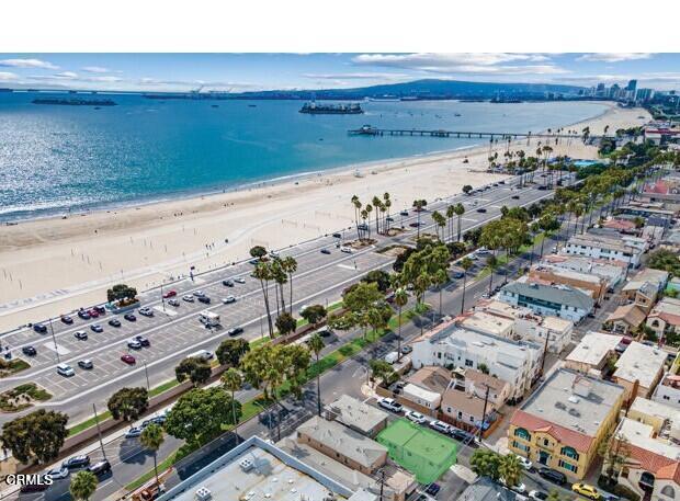 birds eye view of property featuring a water view and a view of the beach